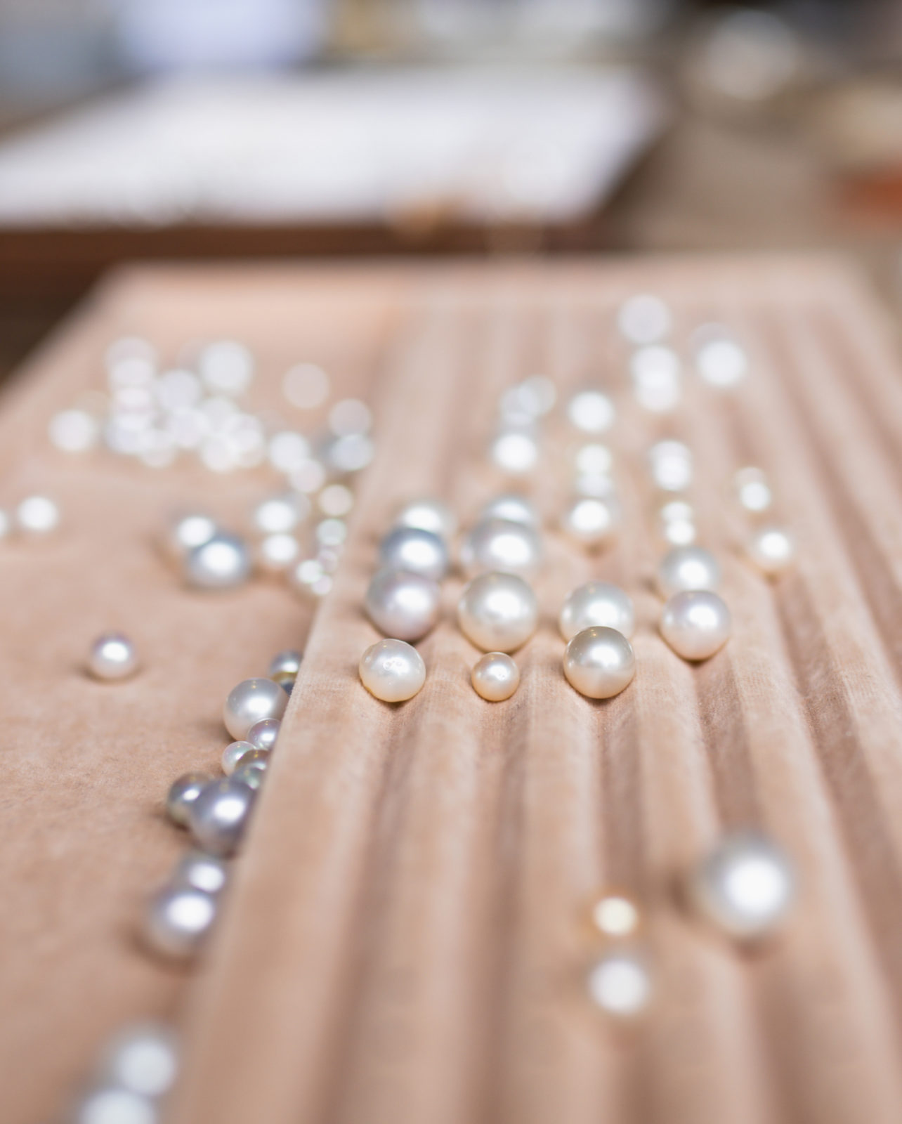 An assortment of Australian pearls, grown at both our Cygnet Bay and Broken Bay pearl farm, sit of a tray ready to be inspected during a Pearl grading experience available at Broken Bay Pearl Farm.