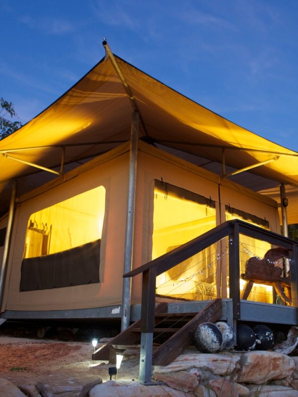 Rainforest Safari Tent A Diver's Creek Glamping Safari Tent glows with it's ambient lighting within at dusk n the unique, rugged landscape of the Diver's Creek site at Cygnet Bay Pearl Farm.