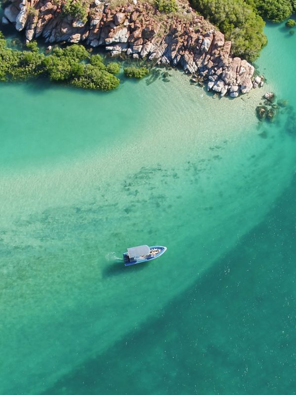 story-bottom.jpg A beautiful aerial visual of a boat dancing across the waves, travelling past the Archipelago Islands that are scattered along the coastline of the Dampier Peninsula, with turquoise blue waters that are almost crystal clear.