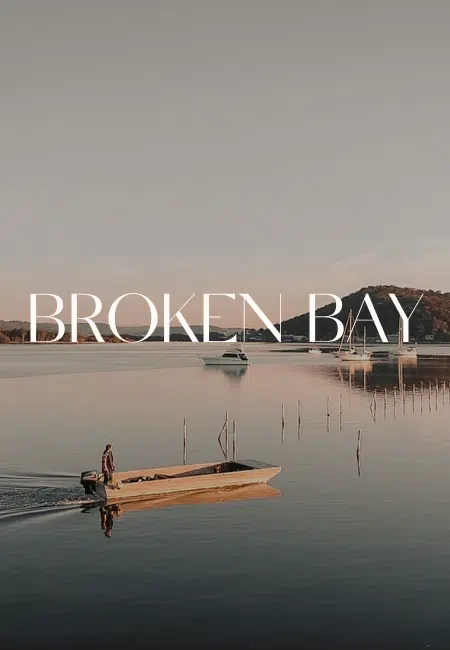 A boat glides across the tranquil waters of Mooney Mooney, towards the oyster leases of Broken Bay Pearl Farm.