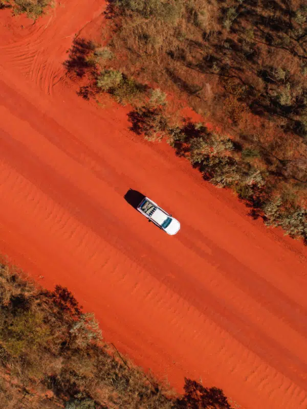 A hired car from BroomeBroome Car Rentals drives to Cygnet Bay Pearl Farm on the red pindan dirt road. Drive, Stay & Discover Offers.