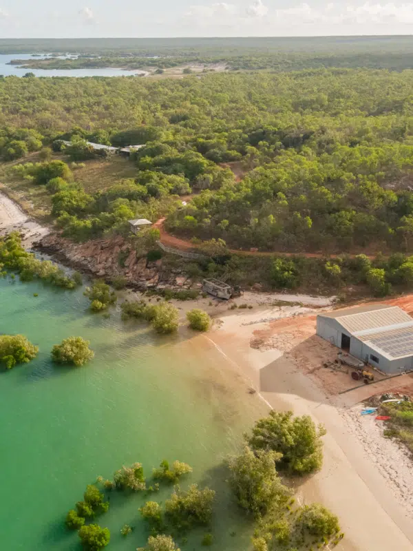 The Cygnet Bay Pearling shack sits on the beach at Cygnet Bay pearl Farm, with the Cygnet Bay waters a few metres away.
