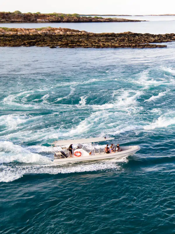 A boat drives through the whirlpools of Cygnet Bay as guests enjoy their Sea Safari, a marine tour quintessential to Cygnet Bay Pearl Farm.
