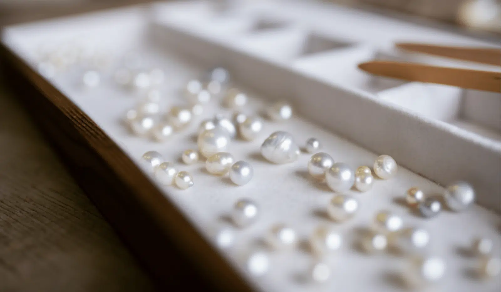 An assortment of Australian pearls, grown at both our Cygnet Bay and Broken Bay pearl farm, sit of a tray ready to be inspected during a Pearl grading experience available at Cygnet Bay Pearl Farm.