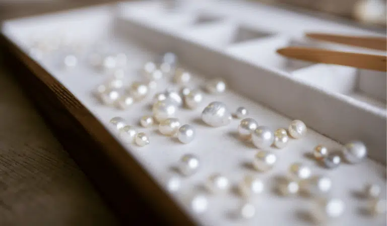An assortment of Australian pearls, grown at both our Cygnet Bay and Broken Bay pearl farm, sit of a tray ready to be inspected during a Pearl grading experience available at Cygnet Bay Pearl Farm.
