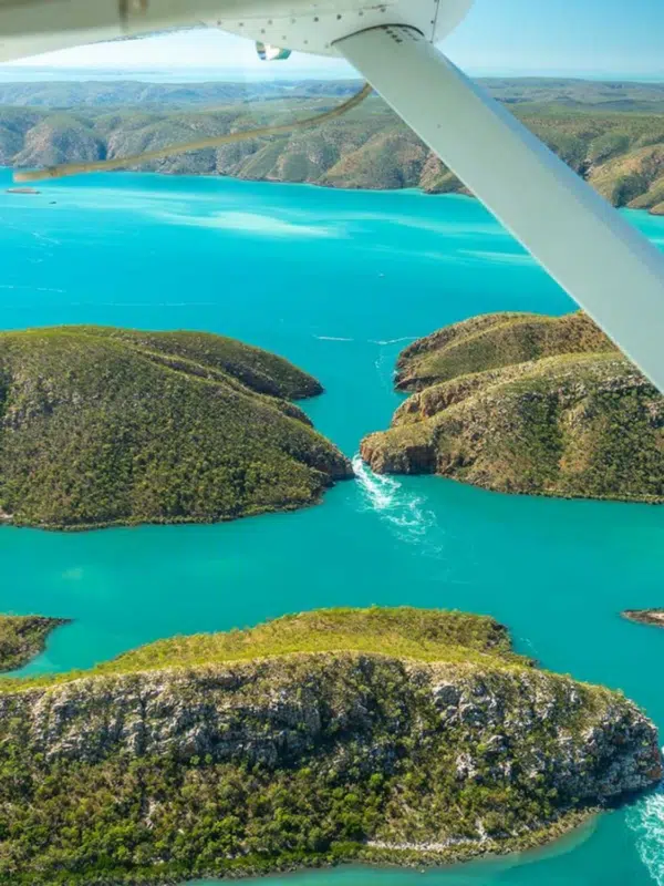 Aerial photo of the Horizontal Falls during a Ventur Atlas tour that takes guests over the falls in a light aircraft to witness the one in a lifetime experience that is the Horizontal Falls phenomenon. The waters of Talbot way are turquoise and still in contrast to the white caps of the rushing water surging through the gap between islands, creating Horizontal Falls.